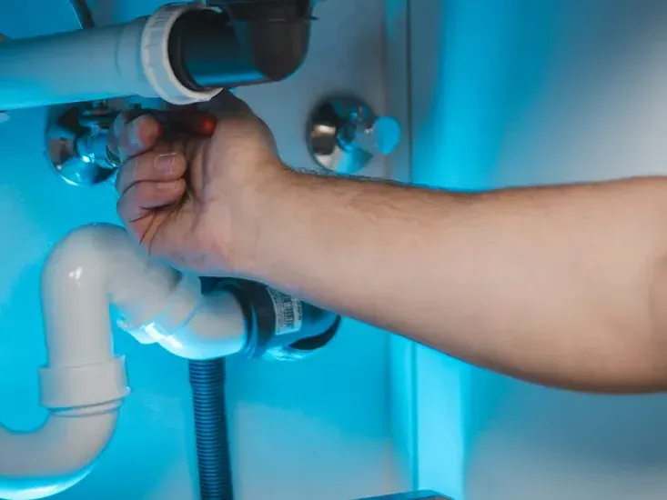 Emergency plumbing repair on a leaking drain pipe in a Nampa home